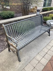 Photo of one of the 12 outdoor patio benches before the restoration. 