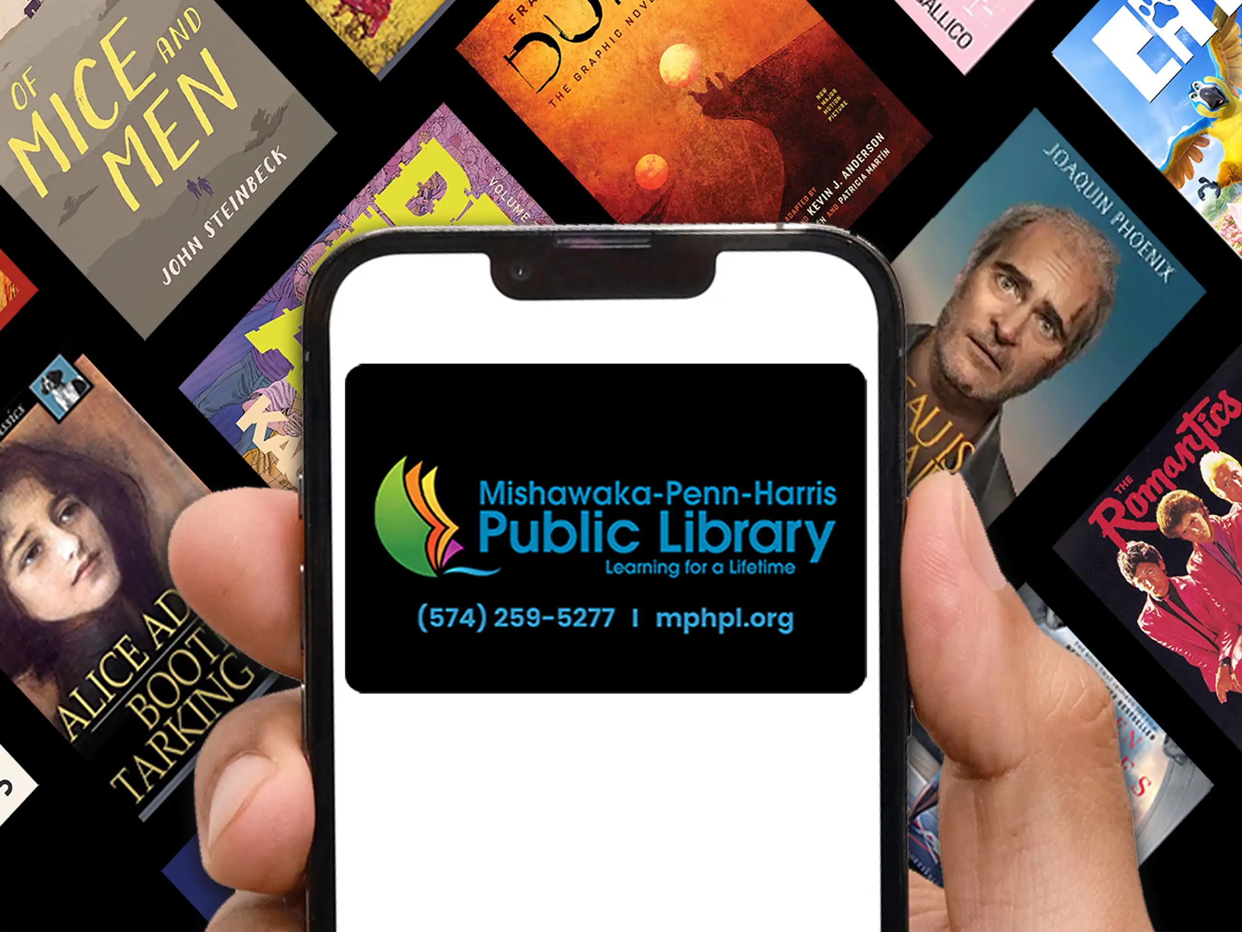 A hand holds a phone displaying the Mishawaka-Penn-Harris Public Library logo, phone number, and website. In the background are various book covers, including Of Mice and Men and Alice and Bob..
