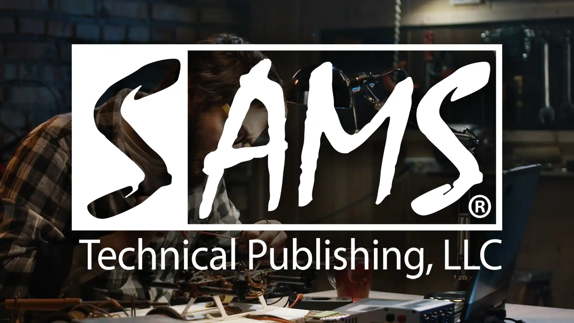 A person works on electronic equipment at a desk in a dimly lit room. The text SAMS Technical Publishing, LLC is prominently displayed over the image.