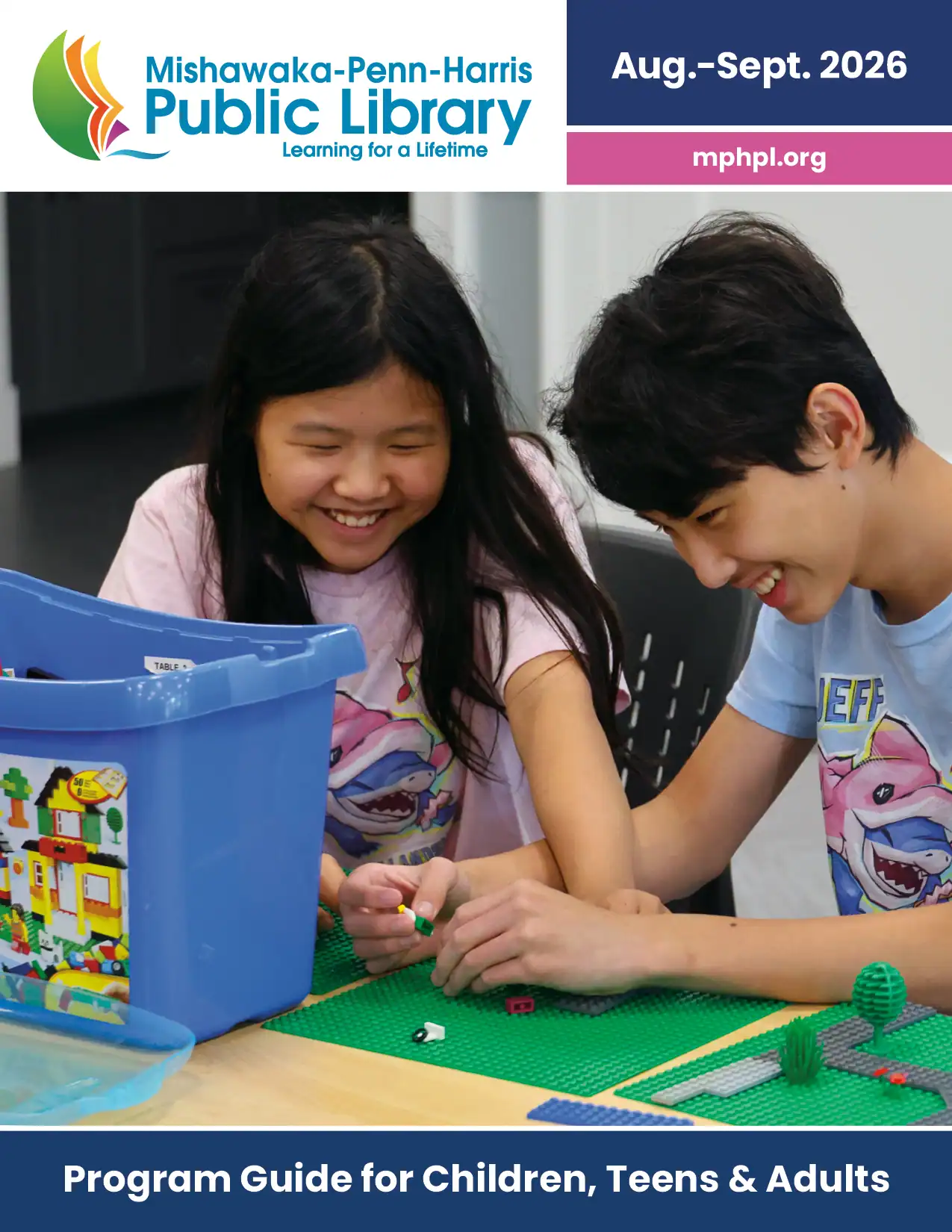 Dec 2025 and Jan 2026 Program guide cover. ‘MPHPL logo, mphpl.org Program Guide for Children, Teens and Adults'. Two teens smile while using building bricks to create a movie scene at the Harris Branch.